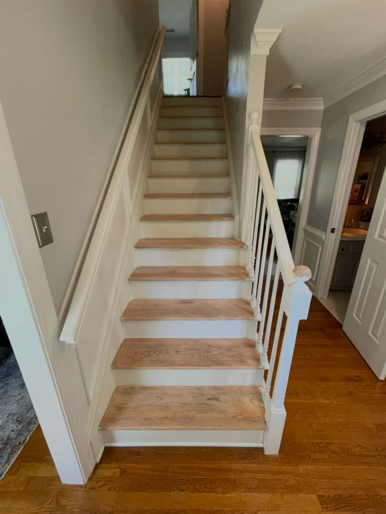 Staircase where the treads have been sanded and the sides and risers are painted white