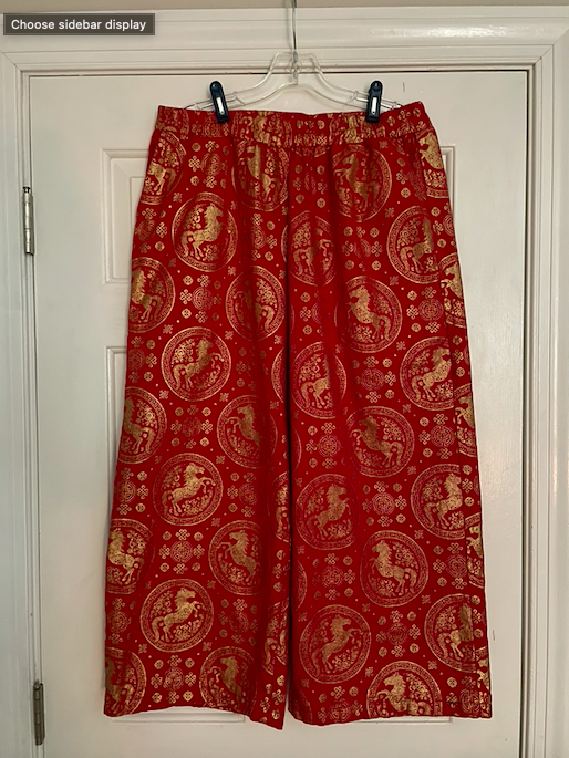 Red pants with golden fire horse pattern.