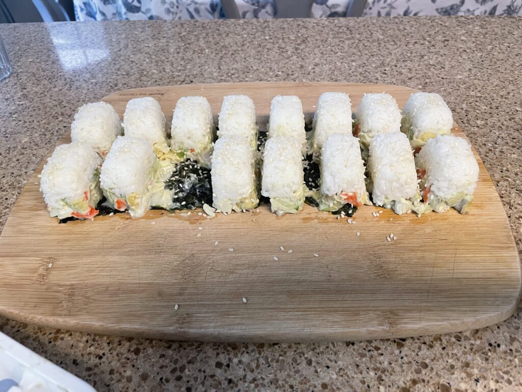 Two rows of sushi with one piece missing