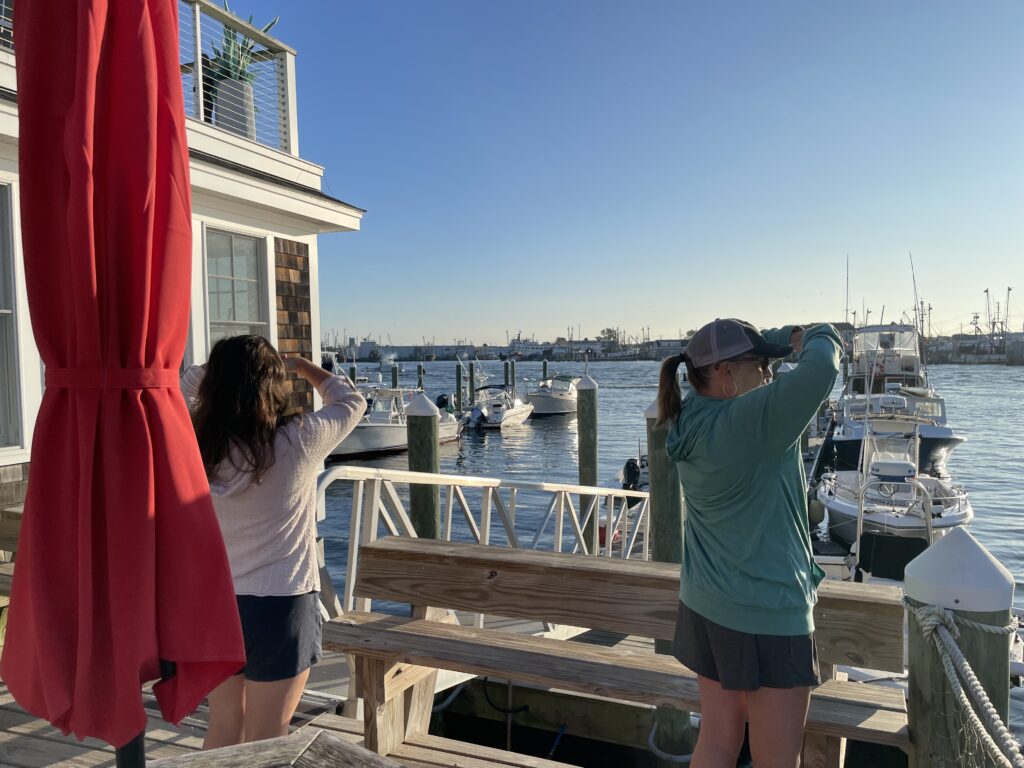 two women standing on a dock